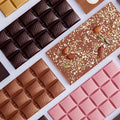 Assortment of MAKAW chocolate bars including dark, milk, blonde, ruby and fruit and nut